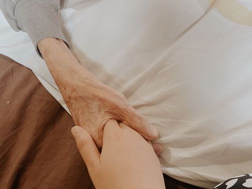 Caregiver holding a resident's hand