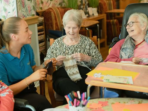 Staff member sharing a warm moment with residents