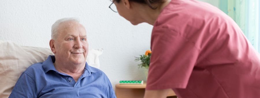 Caregiver serving a meal to a resident